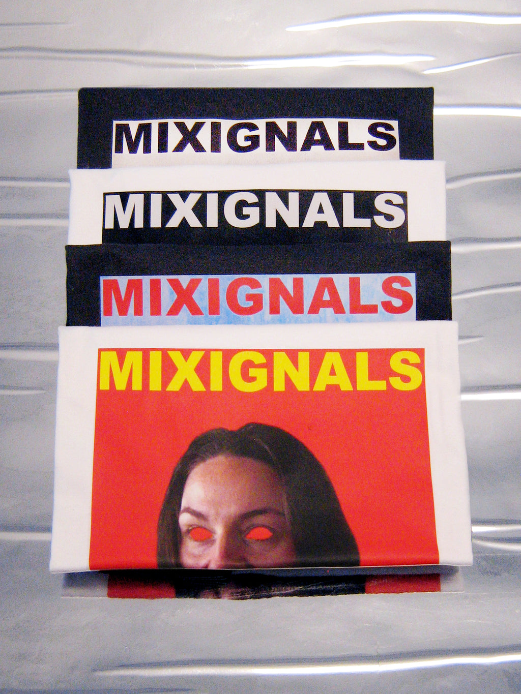 Stacked MIXIGNALS prints with the SIMHASANA lion-pose portrait on orange-red – MIXIGNALS by Alex Beriault